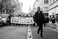 Portrait of man dancing in the street in front of people protesting against the retirement