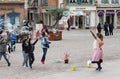 Portrait of woman artiste with soap bubbles in the street on main place