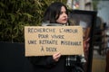 woman protesting with placard in french : cherche l\'amour pour vivre une retraite miserable a