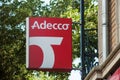 Closeup of Adecco sign on building facade, Adecco is the famous french Temporary work agency