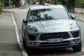 Closeup of blue Porsche Macan on front view parked in the street