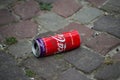 Coca cola can abandonned in the street on cobblestone