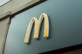 Closeup of Mc Donald`s logo on fast food entry in the street