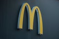 Closeup of Mc Donald`s logo on fast food entry in the street