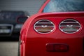 Closeup of rear light of red chevrolet corvette parked in the street Royalty Free Stock Photo