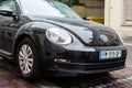 Front view of black Volkswagen new beetle parked in the street Royalty Free Stock Photo