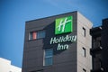 Holiday inn hotel logo on modern building. Holliday Inn is an americain chain company of hostelry