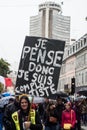 People protesting in the street with banner in french, je pense donc je suis compplotiste, in english, I think I am conspirator Royalty Free Stock Photo