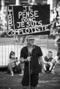 People protesting in the street with banner in french, je pense donc je suis compplotiste, in english, I think I am conspirator Royalty Free Stock Photo