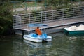 man employee on rental pedalo in the river in the city