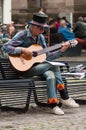 Portrait of old man playing acoustic guitar in the street