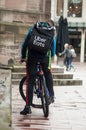 POrtrait of uber eats delivery man in bicycle waiting in the street