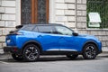 Profile view of blue Peugeot 2008 GT Line parked in the street