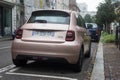 Rear view of pink electric Fiat 500 parked in the street