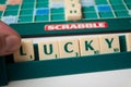 Closeup of plastic letters with word lucky on Scrabble board game