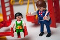 Playmobil figurines at playground for children on white background