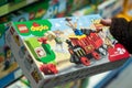 Toy story train by lego duplo in hand of woman in a toy store supermarket