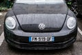 Front view of black Volkswagen new beetle parked in the street Royalty Free Stock Photo