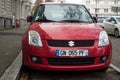 Front view of red suzuki swift parked in the street