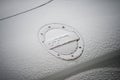 Audi TT logo on tank trap on the white car covered by the snow by snowy day