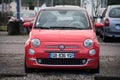 Front view of corail color Fiat 500 parked in the street