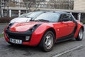 Front view of red smart roadster parked in the street Royalty Free Stock Photo