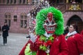 Portrait of masked people parading in the street and playing with confettis