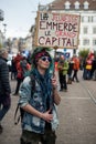 portrait of punk girl protesting with placard in french : la jeunesse emmerde le grand