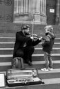 Portrait of street artist playing violin in the street Royalty Free Stock Photo