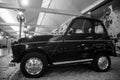 profile view of black renault 4 1969 parked in a showroom
