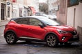 Profile view of red Renault captur parked in the street