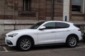 Profile view of white alfa romeo SUV car parked in the street