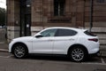 Profile view of white alfa romeo SUV car parked in the street