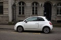 Profile view of white Fiat 500 parked in the street