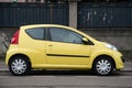 Profile view of yellow Peugeot 107 parked in the street