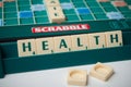 Plastic letters on Scrabble board game with word : Health Royalty Free Stock Photo