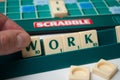 Plastic letters on Scrabble board game with word : Work Royalty Free Stock Photo