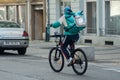 Delivery man with bicycle in the street, deliveroo is a british delivery company in mountain bike
