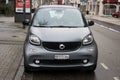 Front view of grey Smart, the famous brand of microcar parked in the street