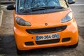 Front view of orang smart parked in the street