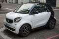 Front view of white Smart car parked in the street