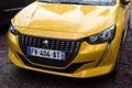 front view of yellow Peugeot 208 gt line parked in the street