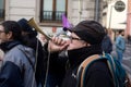 portrait of old man protesting in the street with trumpet