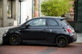 Profile view of black Fiat 500 Abarth parked in the street