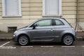 Profile view of Gray Fiat 500 car, the famous italian brand of cars parked in the street