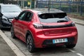 Rear view of new red Peugeot 208 Gt Line parked in the street