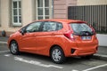 Rear view of orange Honda Jazz parked in the street