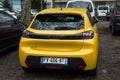 Rear view of yellow Peugeot 208 gt line parked in the street