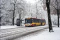 yellow public bus by the Solea compagny rolling during a snowy day