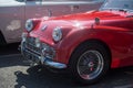 Front view of red retro triumph car parked in the street Royalty Free Stock Photo